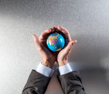 Dünya Çevre bakımı için eller içinde tutan işadamı koruma