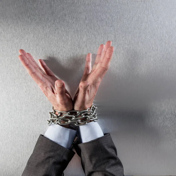 Innocent professional man hands tied with chain for suspicious management — Stock Photo, Image