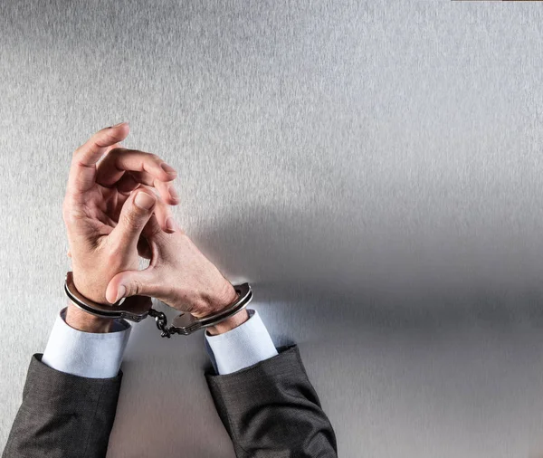 Businessman bothered with handcuffs suffering at office for corporate justice — Stock Photo, Image