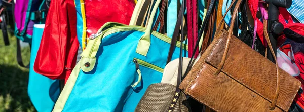 fast fashion bags on display at thrift store to resale