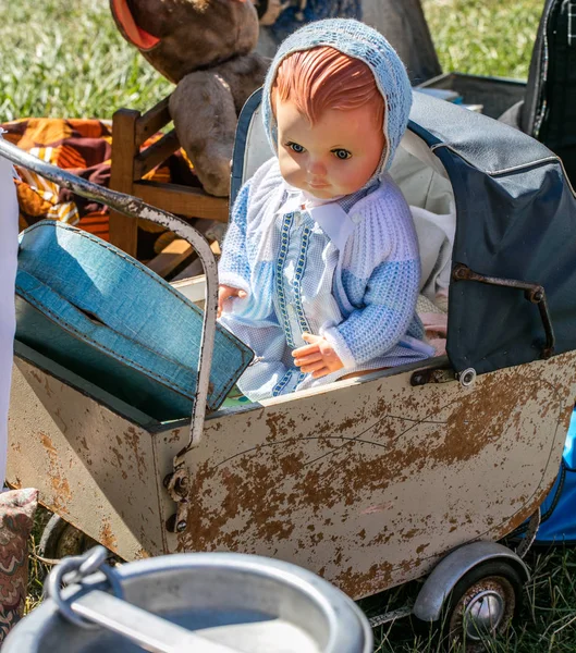 Display of retro baby carriage and doll at garage sale — Stock Image Display of retro baby carriage and doll at garage sale Stock Image