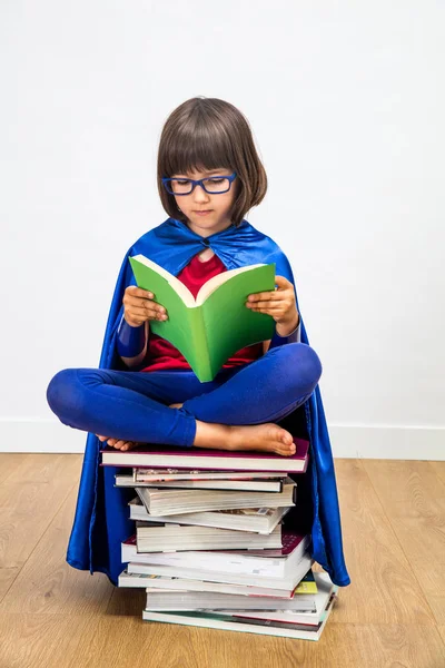 Sabia colegiala con super héroe traje de lectura para chica poder —  Fotos de Stock