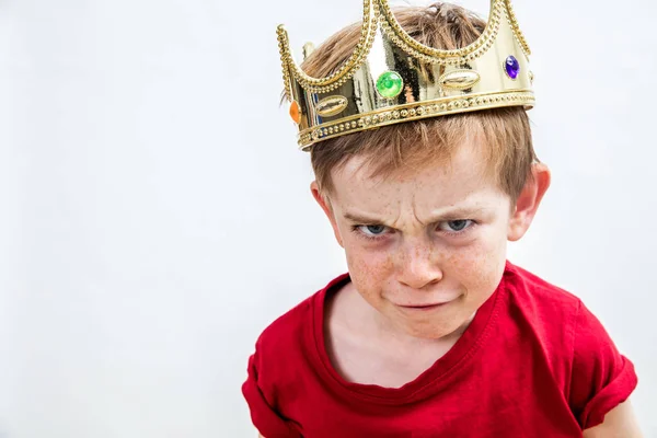 Sulking αστείο πρόσωπο από ένα μικρό αγόρι που φοράει μια κορώνα — Φωτογραφία Αρχείου
