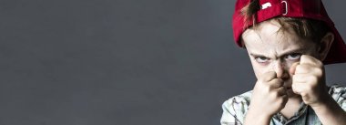 threatening boy with freckles and red hat looking violent, banner clipart