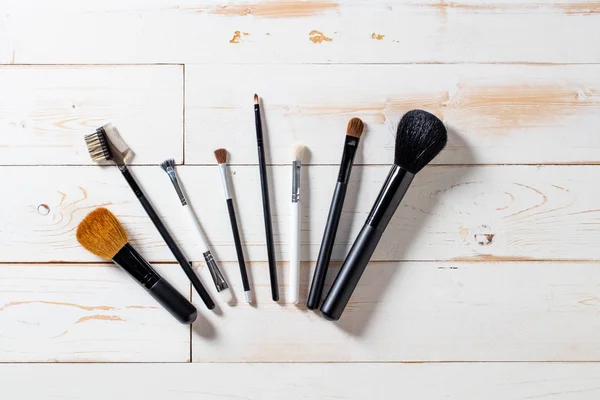Lineup of artist makeup accessories with eyeshadow and blush brushes
