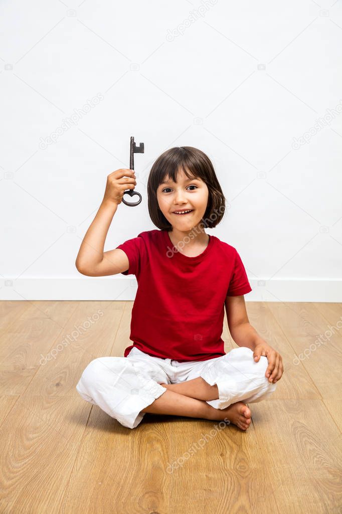 cheerful kid showing key for success, creativity and inspiring career