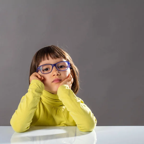 Portrait of serious daydreaming girl thinking with conscious education, studio — Stock Photo, Image