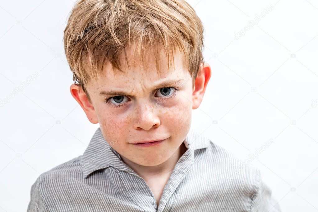 unhappy conflicted child expressing sadness, anger and disappointment, isolated