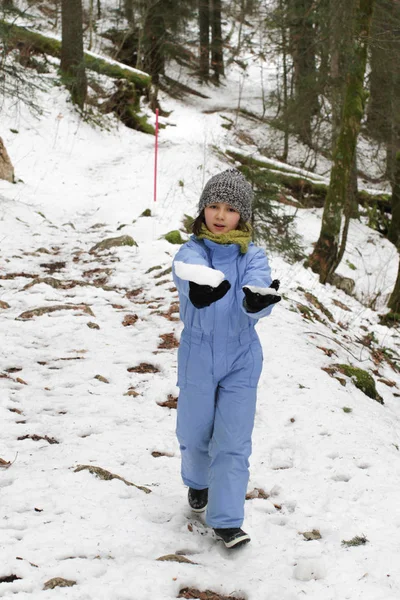 Happy child hiking on a snowy path in mountain woods — 스톡 사진
