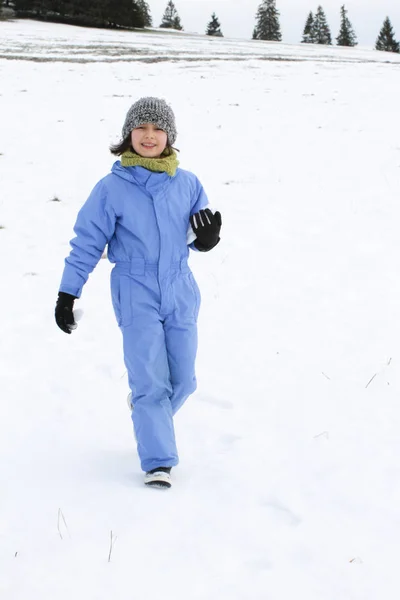 Happy beautiful child walking over snowy mountain, real life nature — 스톡 사진