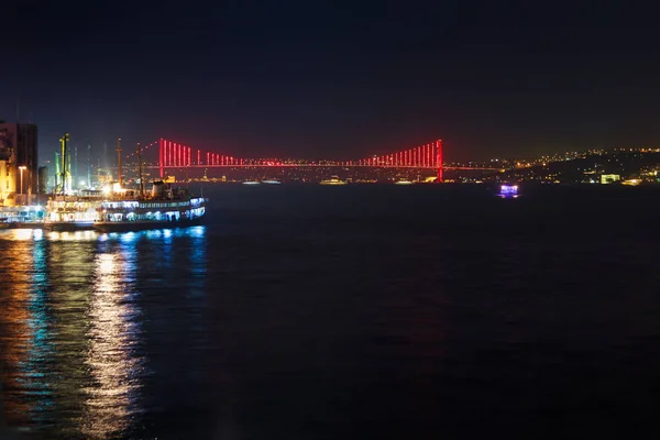 View of Galata quarter on the Bosporus and a bridge in the distance at night. Istanbul. — Stock Photo, Image