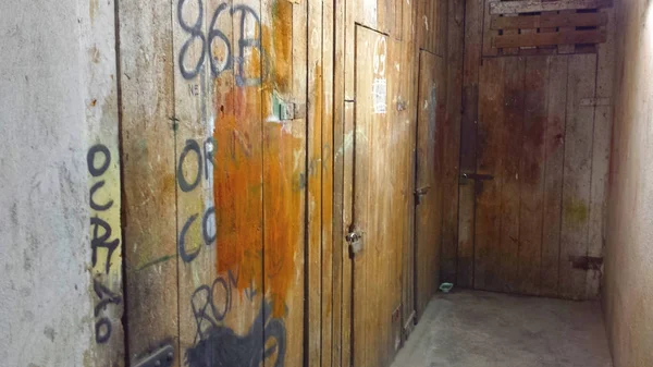 Destroyed basement. Wooden door to the basement closed to a padlock.