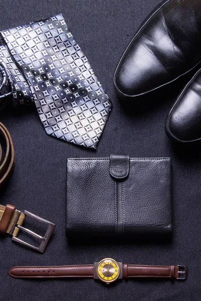 Men\'s accessories on black background tie wallet watch strap sho