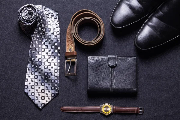Men's accessories on black background tie wallet watch strap sho — Stock Photo, Image