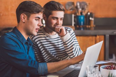 işletme sahipleri dizüstü bilgisayar kullanırken konuşuyor