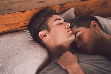 gay couple sleeping arm in arm clipart