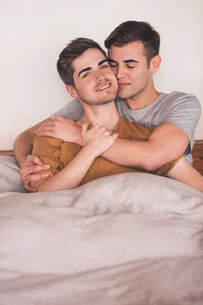 Gay couple lying together in bed — Stock Photo, Image