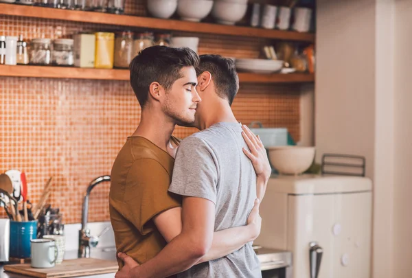 Gay couple hugging each other with eyes closed — Stock Photo, Image