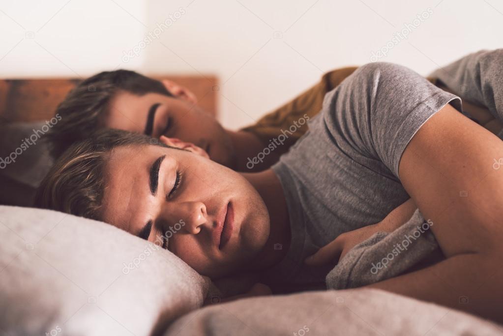 gay couple sleeping arm in arm