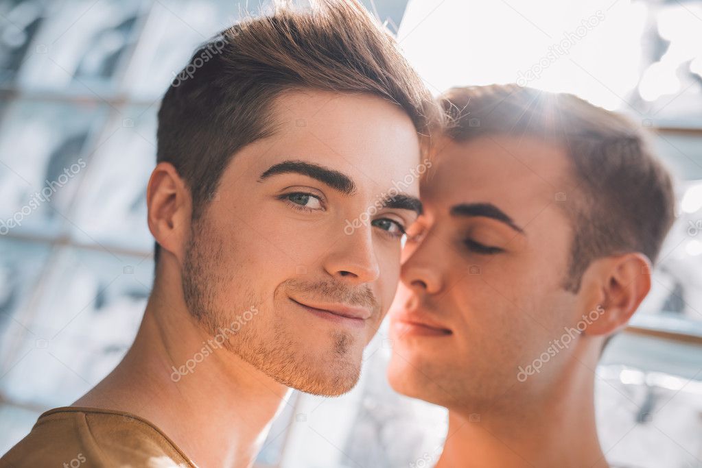 gay couple standing close together