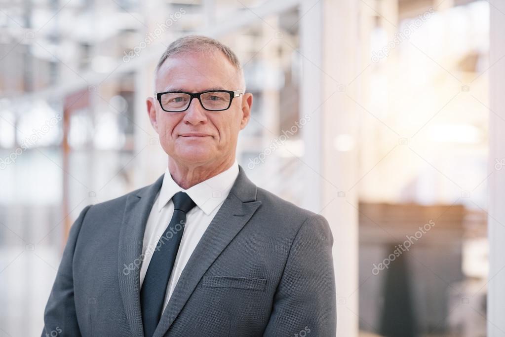 confident mature businessman in glasses