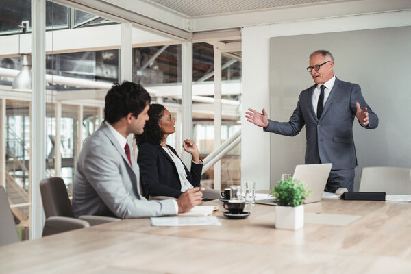 Businessman standing in boardroom giving presentation Royalty Free Stock Images