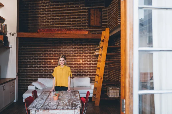 Woman standing at modern loft apartment — Stock Photo, Image