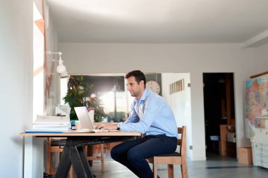 Dizüstü bilgisayarda iş yerinde genç işadamı