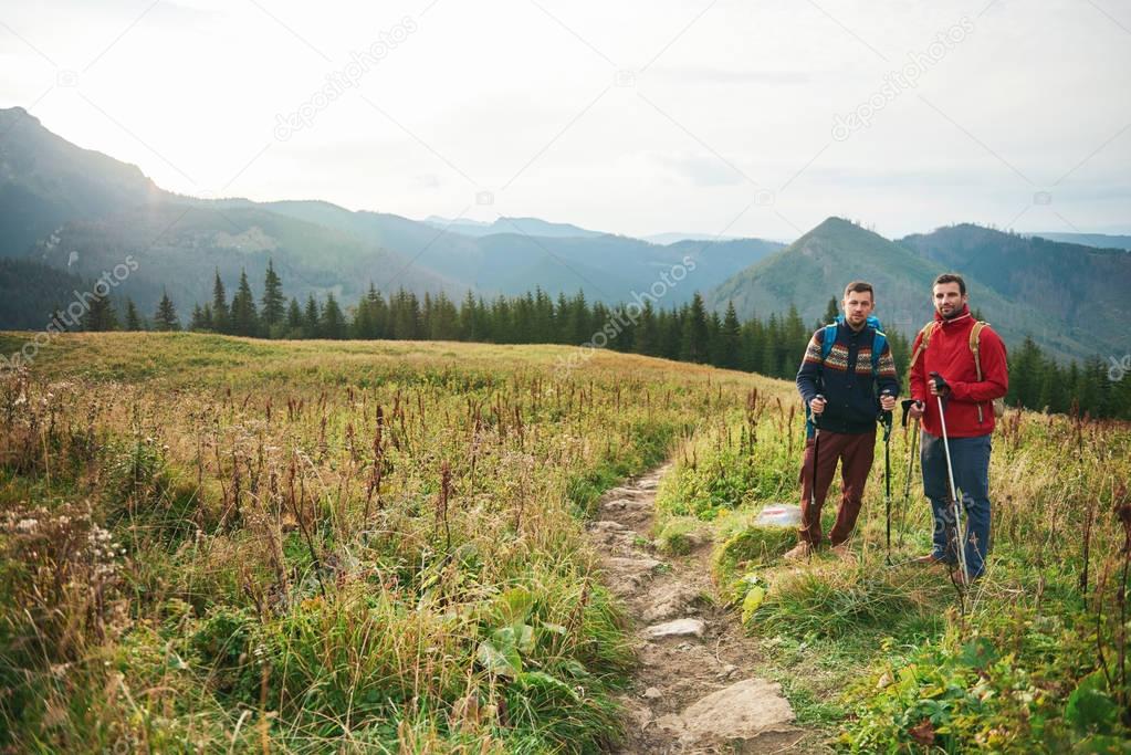 Friends trekking together in great outdoors