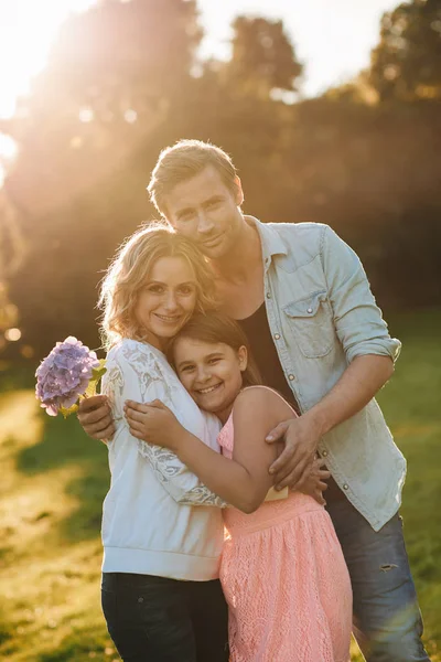 Smiling little girl with of flowers — Stock Photo, Image