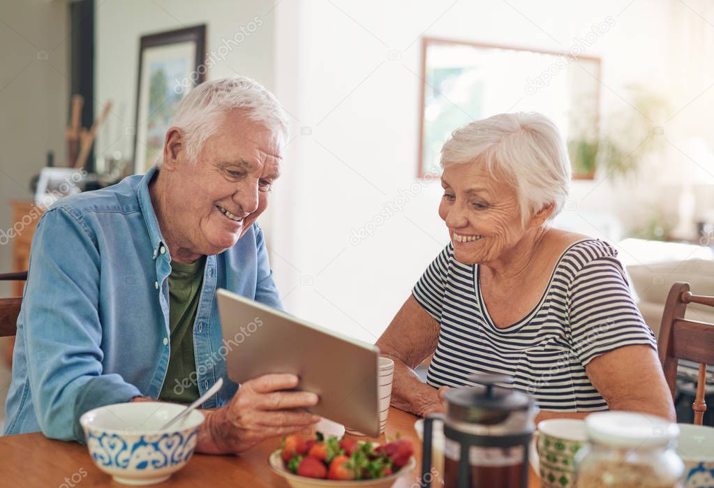 seniors talking over digital tablet 