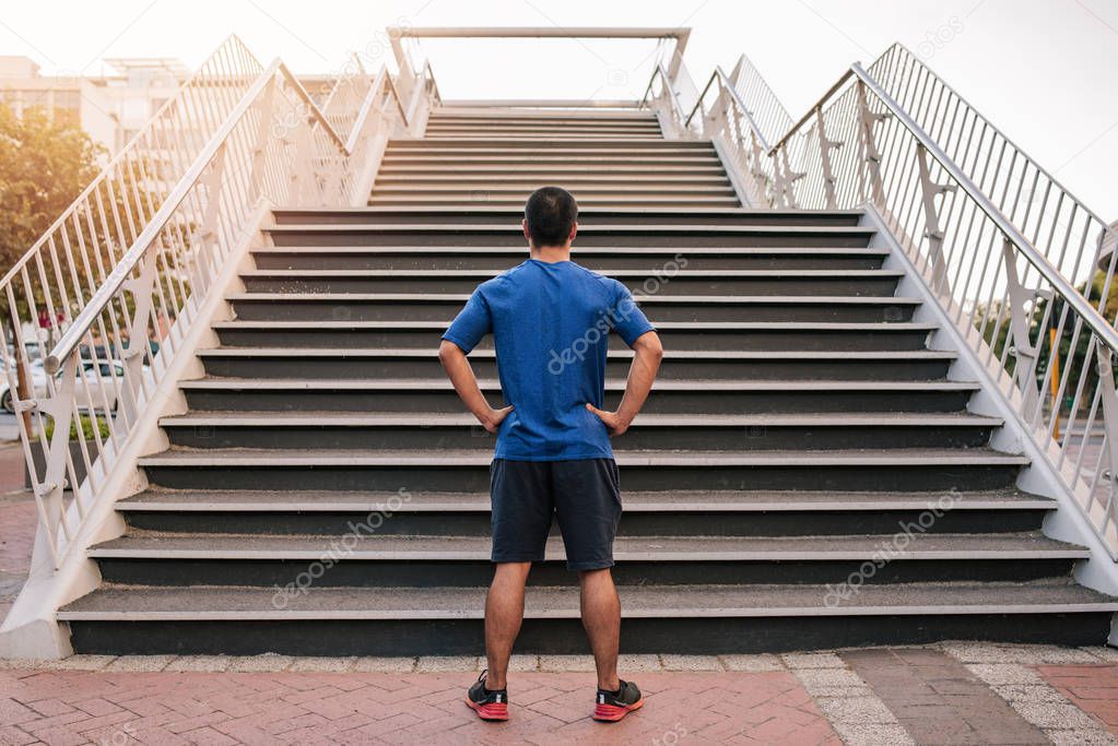 man at bottom of set of stairs