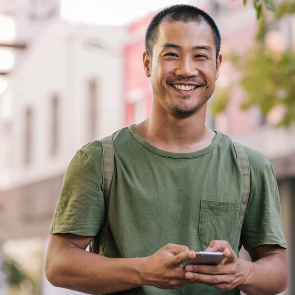Man smiling while standing outside — Stock Photo, Image