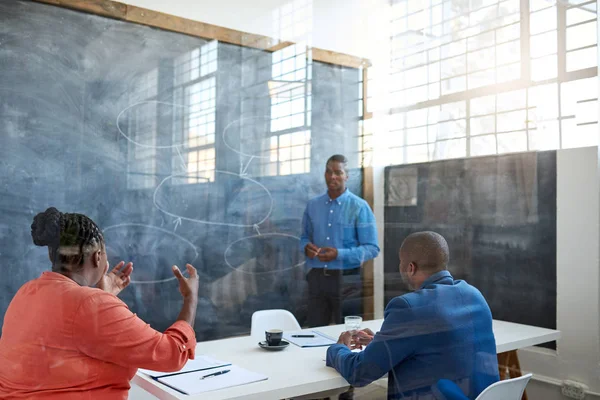 African businessman taking questions — Stock Photo, Image