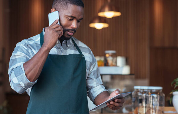 entrepreneur talking on cellphone and using tablet