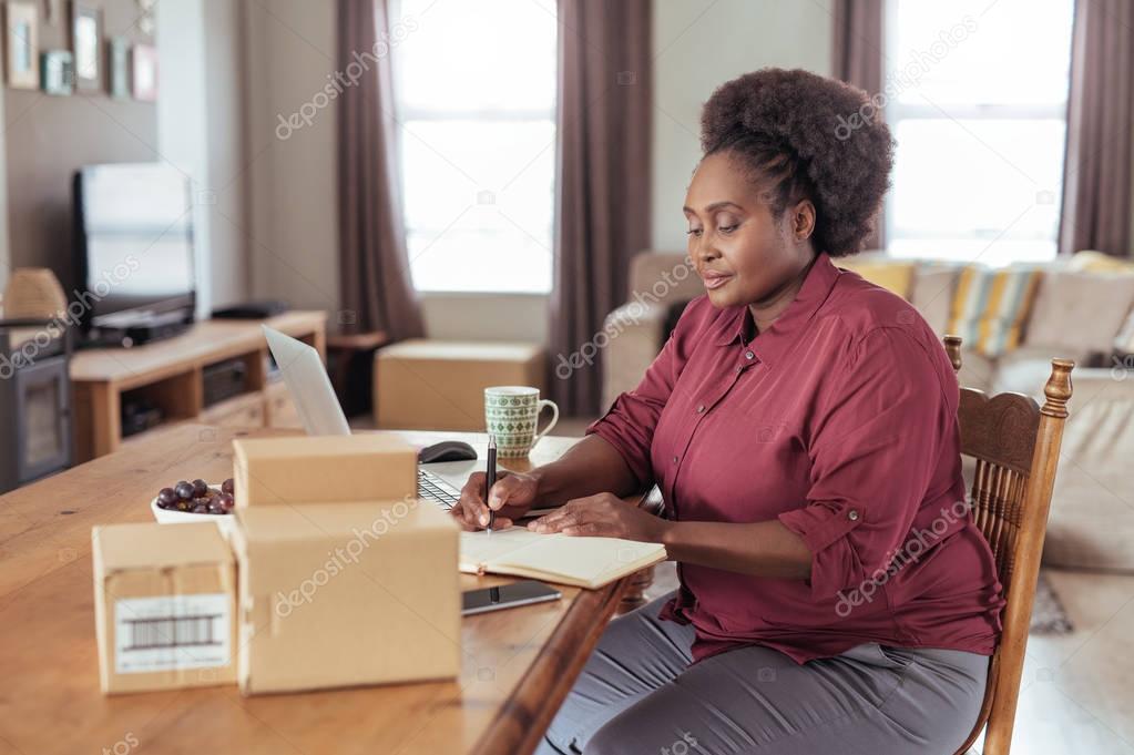 woman writing in notebook 