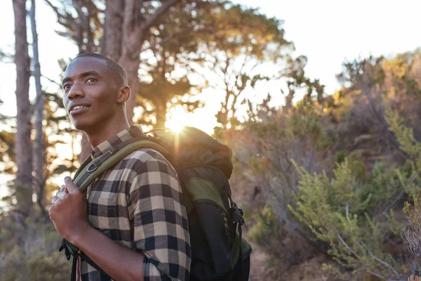 Man wearing backpack standing on trail — Stock Photo, Image