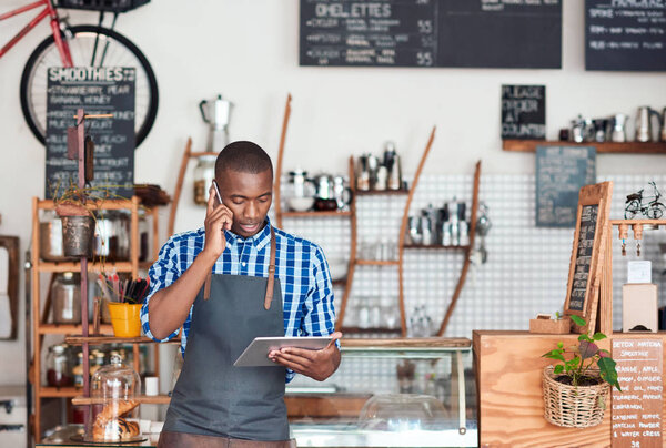 entrepreneur talking on cellphone and using tablet