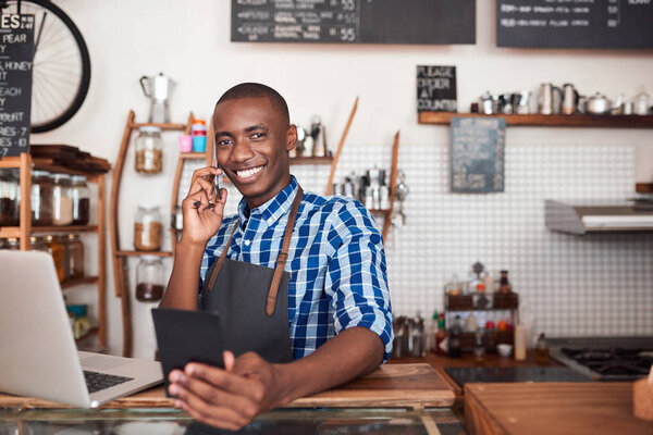 entrepreneur standing at counter of cafe