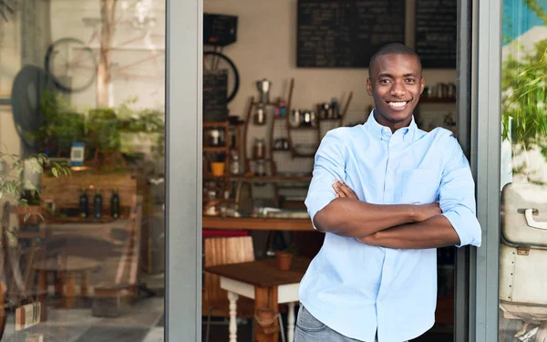 Entrepreneur standing at entrance of cafe — Stock Photo, Image
