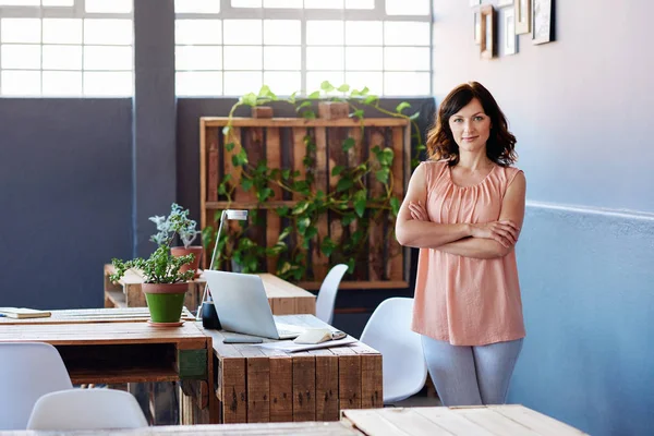 young businesswoman standing alone in office