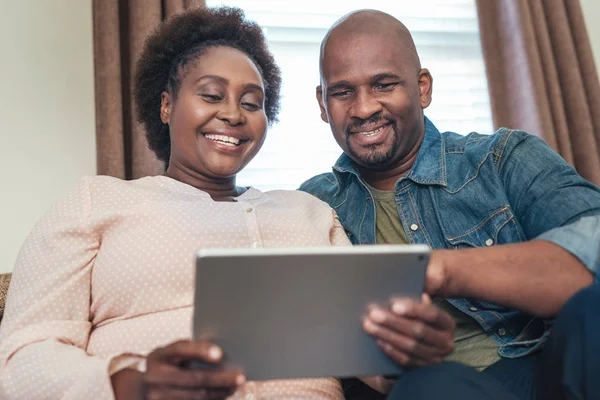 Casal usando tablet digital no sofá — Fotografia de Stock