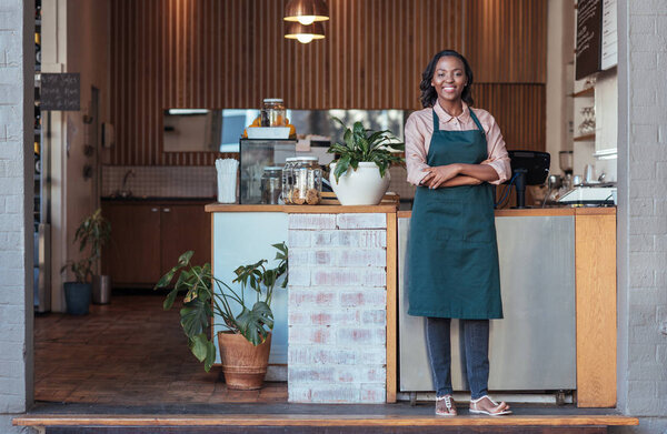 Barista standing welcomingly at counter