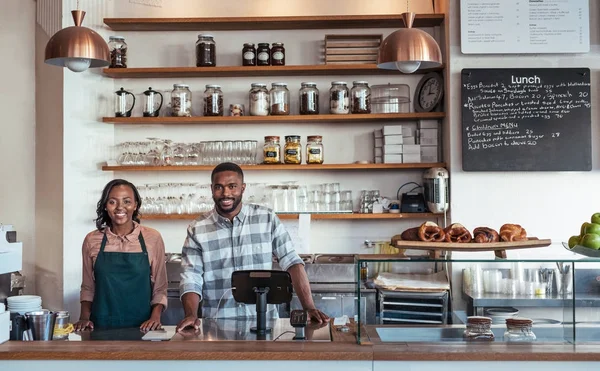 Coffee shop owners standing at counter — Stock Photo, Image