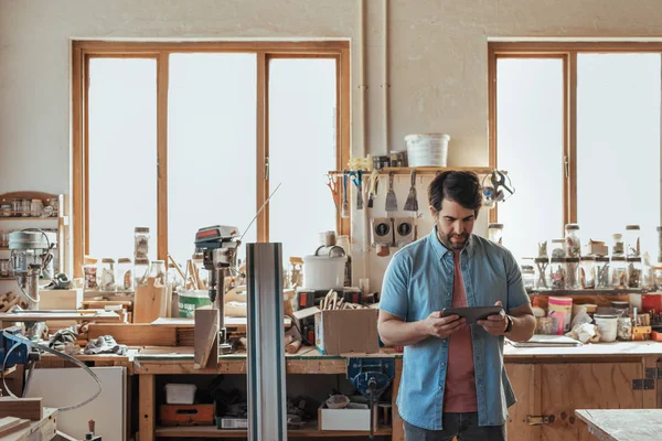 Skilled Young Woodworker Looking Focused While Standing Alone His Workshop — Stock Photo, Image