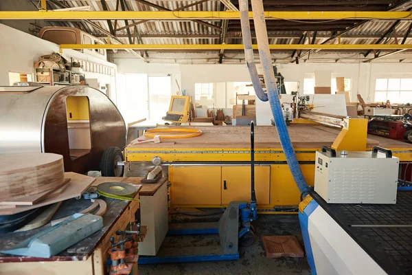 Industrial router in n large woodworking shop — ストック写真