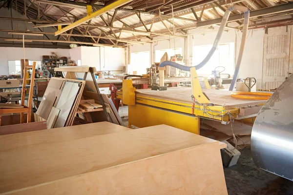 Boards sitting on benches in a woodworking studio — ストック写真