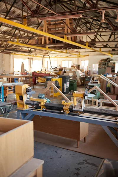 Industrial lathe on the floor of a large woodworking shop — 스톡 사진