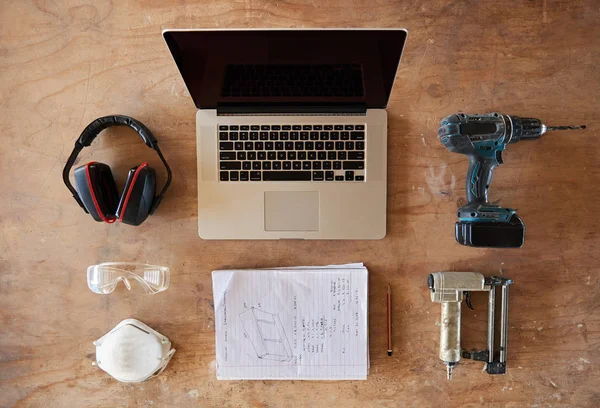 Laptop, plany i narzędzia na stole warsztatowym — Zdjęcie stockowe