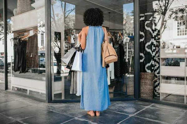 Rearview Woman Standing Sidewalk Looking Window Display Clothing Store While — 스톡 사진